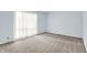 Bright, neutral bedroom featuring plush carpeting and a large window with sheer curtains for natural light at 3425 Ireland Dr, Indianapolis, IN 46235