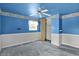 Blue bedroom with neutral carpet, closet, and ceiling fan at 3425 Ireland Dr, Indianapolis, IN 46235
