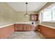 Functional dining room featuring wood cabinetry, vinyl flooring, and ample counter space at 3425 Ireland Dr, Indianapolis, IN 46235