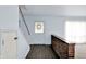 Bright foyer featuring wood floors, staircase, brick half wall, and natural light streaming in from sheer curtained window at 3425 Ireland Dr, Indianapolis, IN 46235