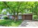 Charming two-story home featuring a brick facade, complemented by a well-maintained lawn and mature trees at 3425 Ireland Dr, Indianapolis, IN 46235