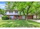 Charming two-story home featuring a brick facade, complemented by a well-maintained lawn and mature trees at 3425 Ireland Dr, Indianapolis, IN 46235