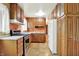 Functional kitchen featuring wood cabinetry, stainless steel appliances, and ample counter space at 3425 Ireland Dr, Indianapolis, IN 46235