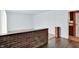 Inviting living room area featuring wood flooring, brick half wall, with neutral carpeting in the spacious living area at 3425 Ireland Dr, Indianapolis, IN 46235