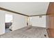 Living room featuring carpet and access to the stairway at 3425 Ireland Dr, Indianapolis, IN 46235
