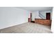 Inviting living room area featuring neutral carpeting, brick half wall, with staircase and access to other rooms at 3425 Ireland Dr, Indianapolis, IN 46235