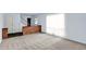 Inviting living room area featuring neutral carpeting, brick half wall, with staircase and access to other rooms at 3425 Ireland Dr, Indianapolis, IN 46235