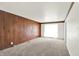 Spacious living room featuring wood paneling and carpet at 3425 Ireland Dr, Indianapolis, IN 46235