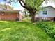Spacious backyard featuring a well-maintained lawn, mature trees and partial fence at 3520 Lantern Ln, Columbus, IN 47203