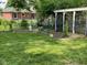 Manicured backyard with a combination of green space, landscaping, and fencing at 3520 Lantern Ln, Columbus, IN 47203