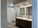 Stylish bathroom with a double sink vanity, modern fixtures and a shower with white subway tile at 3520 Lantern Ln, Columbus, IN 47203