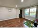 Bedroom with neutral walls and trim, hardwood floors, large windows, and plenty of sunlight at 3520 Lantern Ln, Columbus, IN 47203