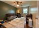 Bedroom with wood floors, crib and ceiling fan at 3520 Lantern Ln, Columbus, IN 47203