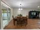 An elegant dining area with hardwood floors, chandelier, and sliding door to the enclosed patio at 3520 Lantern Ln, Columbus, IN 47203