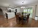 Dining room with hardwood floors and contemporary lighting adjacent to modern kitchen at 3520 Lantern Ln, Columbus, IN 47203