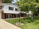 Charming home featuring brick and white siding, manicured lawn, and black window shutters at 3520 Lantern Ln, Columbus, IN 47203