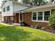 Front yard view of brick home with updated windows and landscaped garden at 3520 Lantern Ln, Columbus, IN 47203