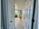 A bright hallway with tile flooring and doors leading to different rooms at 3520 Lantern Ln, Columbus, IN 47203