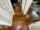 Hallway with hardwood floors with the open doors on the bedrooms at 3520 Lantern Ln, Columbus, IN 47203