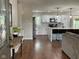 Open-concept kitchen features white cabinets, stainless steel appliances, and hardwood floors at 3520 Lantern Ln, Columbus, IN 47203
