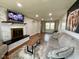 Open-concept living room featuring a fireplace, wood floors, and a comfortable sofa at 3520 Lantern Ln, Columbus, IN 47203
