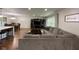 Open-concept living room featuring hardwood floors, a sectional couch, and dining area at 3520 Lantern Ln, Columbus, IN 47203