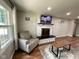 Cozy living room with a brick fireplace, wood floors, and lots of natural light at 3520 Lantern Ln, Columbus, IN 47203