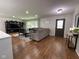 Bright living room with wood floors, a comfortable sofa, and a large entertainment center at 3520 Lantern Ln, Columbus, IN 47203