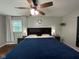 A primary bedroom with ceiling fan and large bed at 3520 Lantern Ln, Columbus, IN 47203