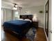 A primary bedroom featuring a large bed with storage drawers, a ceiling fan and modern decor at 3520 Lantern Ln, Columbus, IN 47203