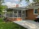 Brick patio and sunroom that offers outdoor dining and lounging at 3520 Lantern Ln, Columbus, IN 47203