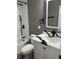 This renovated bathroom includes a modern vanity with black fixtures and a sleek mirror at 3949 Chateau Dr, Indianapolis, IN 46226