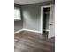 Bedroom with gray walls, white trim, wood floors, and a closet at 3949 Chateau Dr, Indianapolis, IN 46226