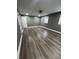 Gray bedroom featuring modern lighting fixture, windows, and wide-plank flooring at 3949 Chateau Dr, Indianapolis, IN 46226