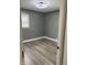 A gray-painted bedroom featuring modern light fixture and wide-plank flooring at 3949 Chateau Dr, Indianapolis, IN 46226