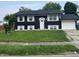 Two story home featuring a dark exterior and white shutters with an attached garage at 3949 Chateau Dr, Indianapolis, IN 46226