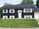 Two story home featuring a dark exterior and white shutters with an attached garage at 3949 Chateau Dr, Indianapolis, IN 46226