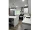Modern kitchen featuring an island, stainless steel appliances, designer backsplash, and hardwood floors at 3949 Chateau Dr, Indianapolis, IN 46226