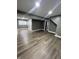 Spacious gray living room with new floors and modern lighting ready for furnishings at 3949 Chateau Dr, Indianapolis, IN 46226