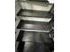 Dark wood stairs with metal railings provide access to upper level at 3949 Chateau Dr, Indianapolis, IN 46226
