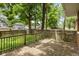 Wooden deck with railings surrounded by lush greenery, providing a serene outdoor space for relaxation and entertainment at 4048 N College Ave, Indianapolis, IN 46205