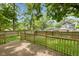 Cozy back deck perfect for entertaining or relaxing, with views of the yard and mature trees at 4048 N College Ave, Indianapolis, IN 46205