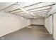 Unfinished basement with painted floor and visible ceiling fixtures, offering a blank canvas for customization at 4048 N College Ave, Indianapolis, IN 46205
