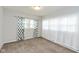 Bright bedroom with neutral carpet, large windows and decorative curtains at 4048 N College Ave, Indianapolis, IN 46205