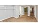Bedroom with neutral carpet, wall shelving, and an adjoining bathroom for convenience and functionality at 4048 N College Ave, Indianapolis, IN 46205