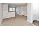 Spacious bedroom featuring neutral carpet, an attached bathroom, and wall shelving for added storage at 4048 N College Ave, Indianapolis, IN 46205
