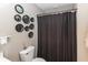 Compact bathroom with a black shower curtain and decorative mirrors at 420 Beverly Ct, Carmel, IN 46032