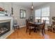 Cozy dining area next to fireplace with wooden table and lots of natural light at 420 Beverly Ct, Carmel, IN 46032