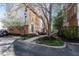 Attractive brick townhome with mature trees and a paved walkway leading to the entrance at 420 Beverly Ct, Carmel, IN 46032