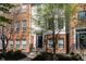 Charming brick townhome featuring a black front door and lush green tree in front at 420 Beverly Ct, Carmel, IN 46032